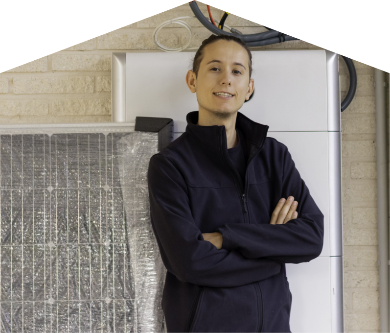 Moore & Russell specialist standing confidently with arms crossed beside newly delivered system components, including a wrapped panel and wall-mounted utility unit. Moore & Russell specialist standing confidently with arms crossed beside newly delivered system components, including a wrapped panel and wall-mounted utility unit.
