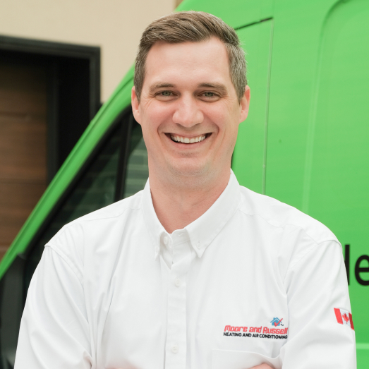 Moore & Russell technician standing by our famous green trucks in a residential neighbourhood. Moore & Russell technician standing by our famous green trucks in a residential neighbourhood.