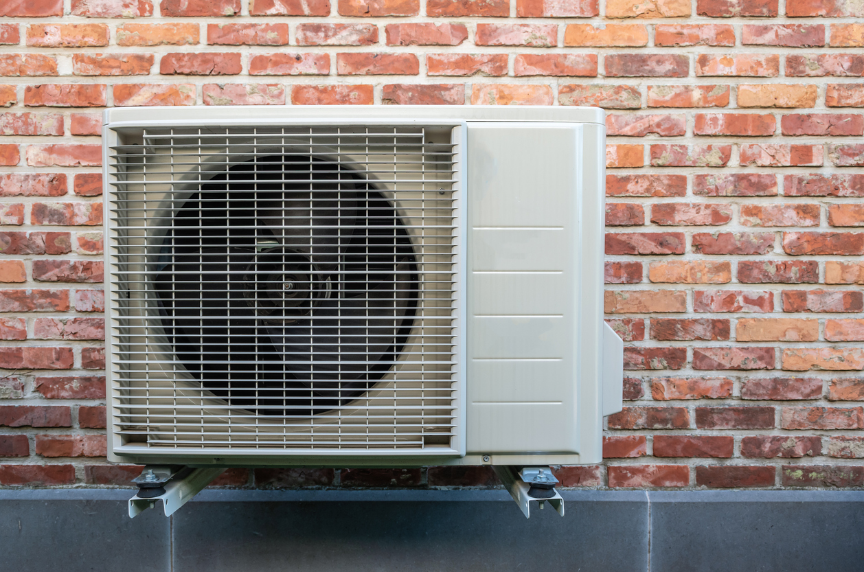 Heat pump air conditioning outdoor unit on wall. Heat pump air conditioning outdoor unit on wall.