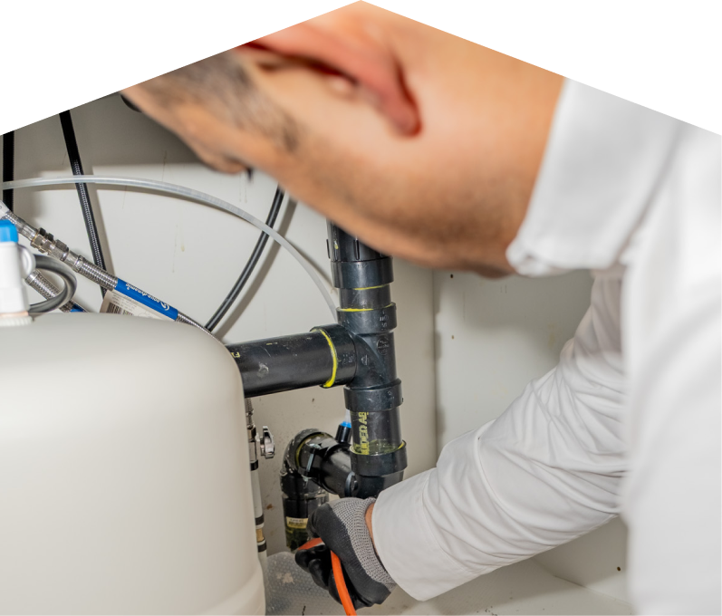 A Moore and Russell plumbing specialist uses a hydro jet to clear a clogged drain. A Moore and Russell plumbing specialist uses a hydro jet to clear a clogged drain.
